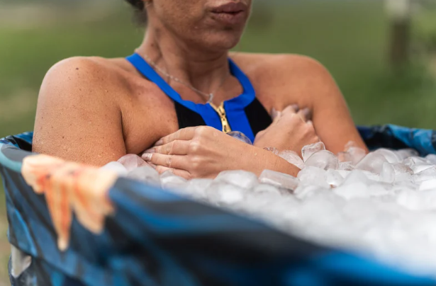 person in ice bath demonstrating the benefits of cold plunges for recovery and wellness