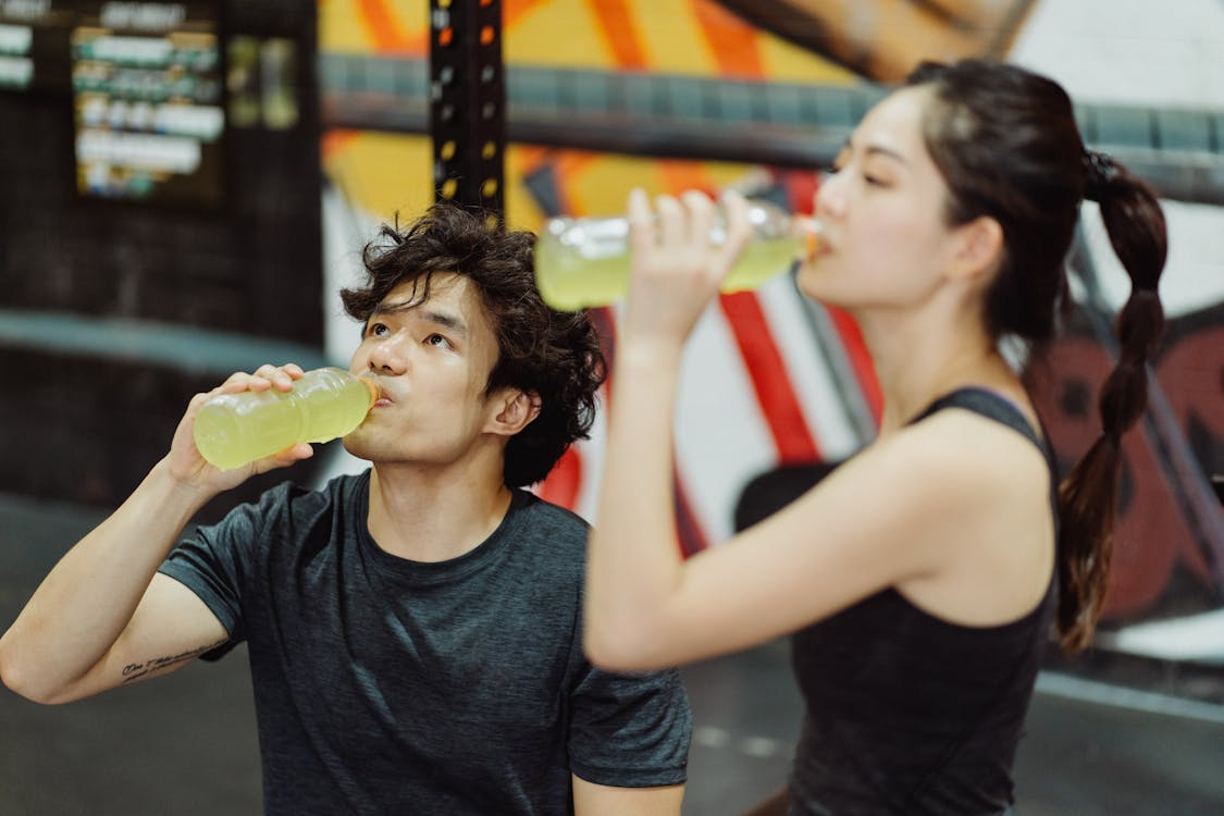 Athletes drinking sports drinks illustrating the truth about hydration and electrolytes after exercise