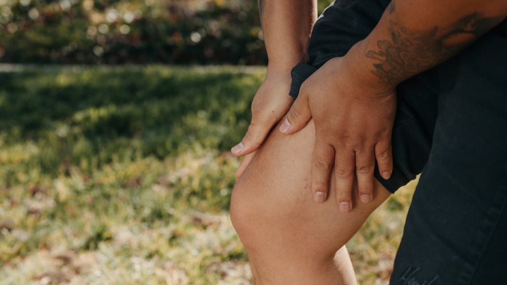 person holding knee showing what happens during inflammation after injury