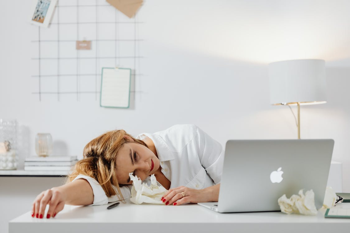 person exhausted at desk illustrating what happens to your body during stress